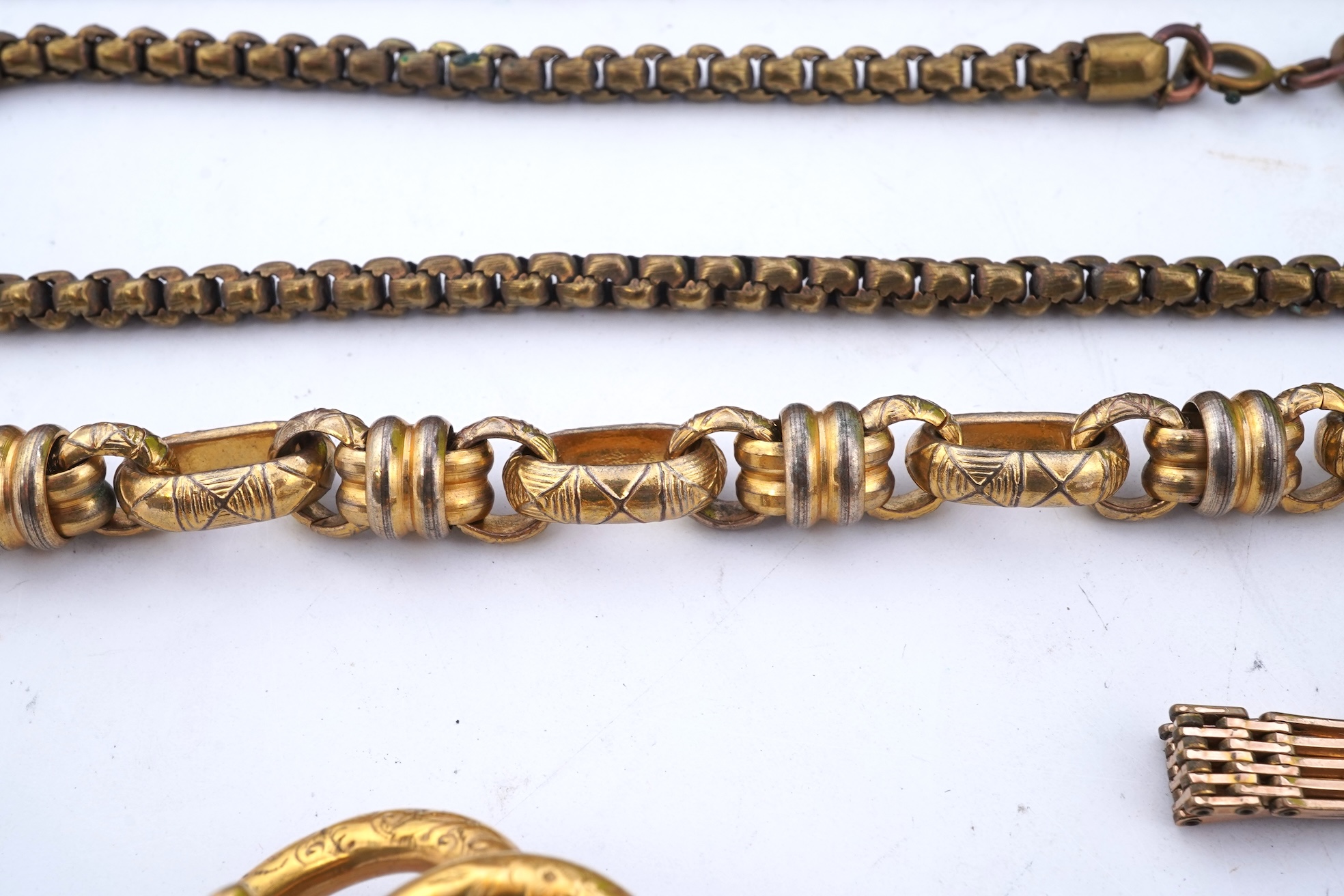 A group of gilt metal/pinchbeck jewels, 19th and early 20th century, comprising: a brooch of knotted design; two gate bracelets; a fancy link bracelet; an open-faced pocket watch; two oval panel brooches, and two watch c